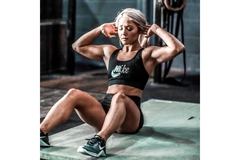 Fit woman at the gym working out doing sit ups